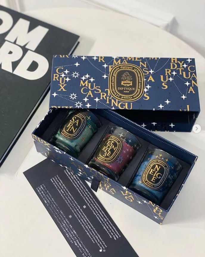 Diptyque Limited Edition Scented Candles Gift Set, which includes three 70g candles in star-adorned packaging.